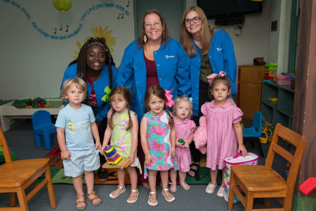 three women with small children